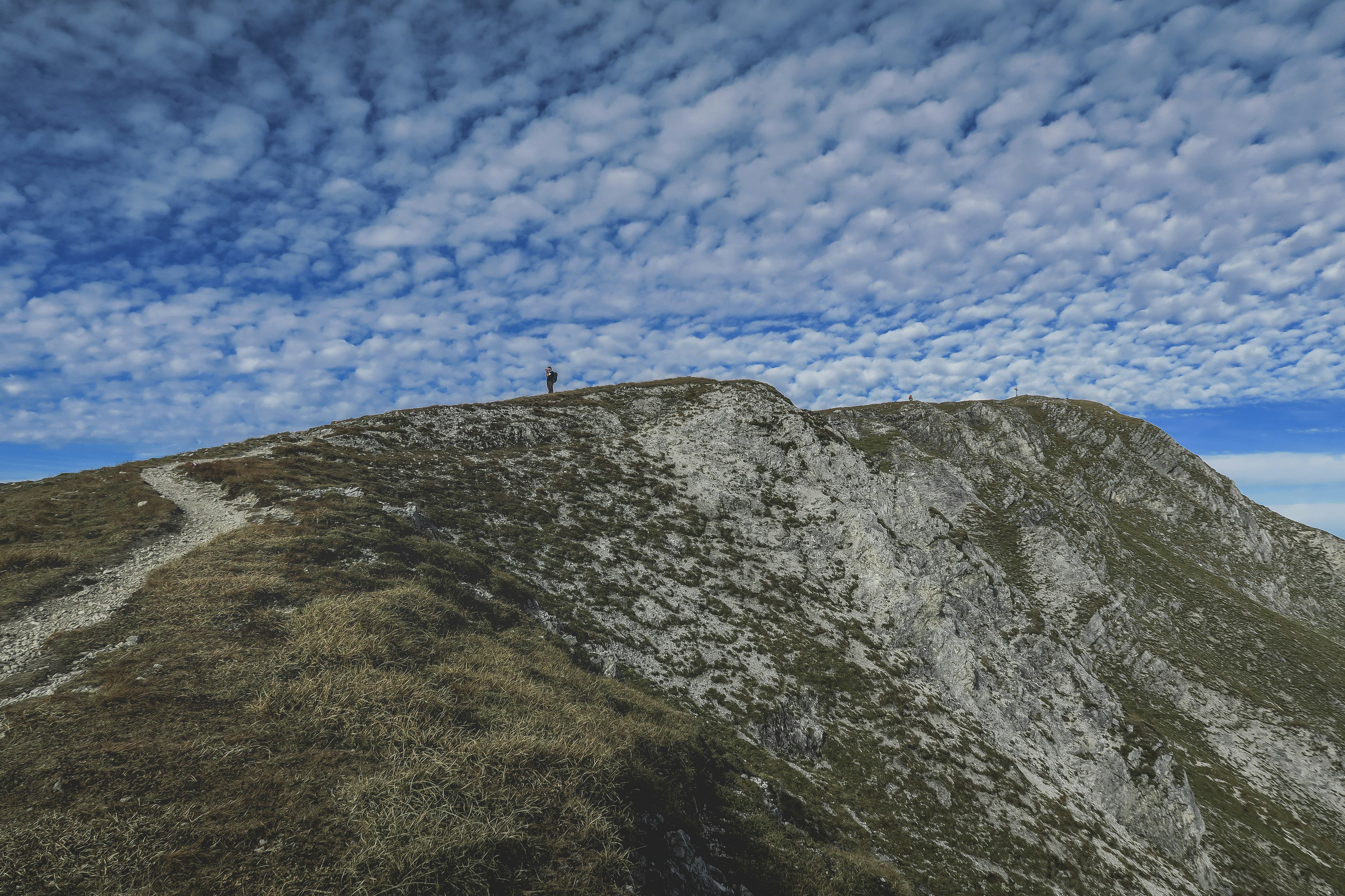 person standing on mountain during daytime